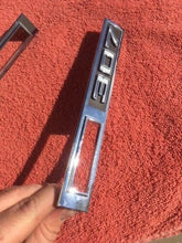 Load image into Gallery viewer, 1969 Chevrolet Chevelle Malibu 307 NOS Front Fender Side Marker Emblem Trim Pair #3945291 / 3945252