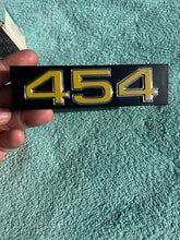 Load image into Gallery viewer, 1975 1976 Chevrolet Pickup Truck C10 C20 C30 NOS "454" Grille Emblem #357286 (cast 343992)
