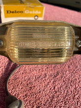Load image into Gallery viewer, 1966-1971 Chevrolet NOS Delco GUIDE License Plate Lamp Lens Assembly #910967